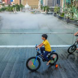 Joyful bicycle ride by River Of Life in the evening